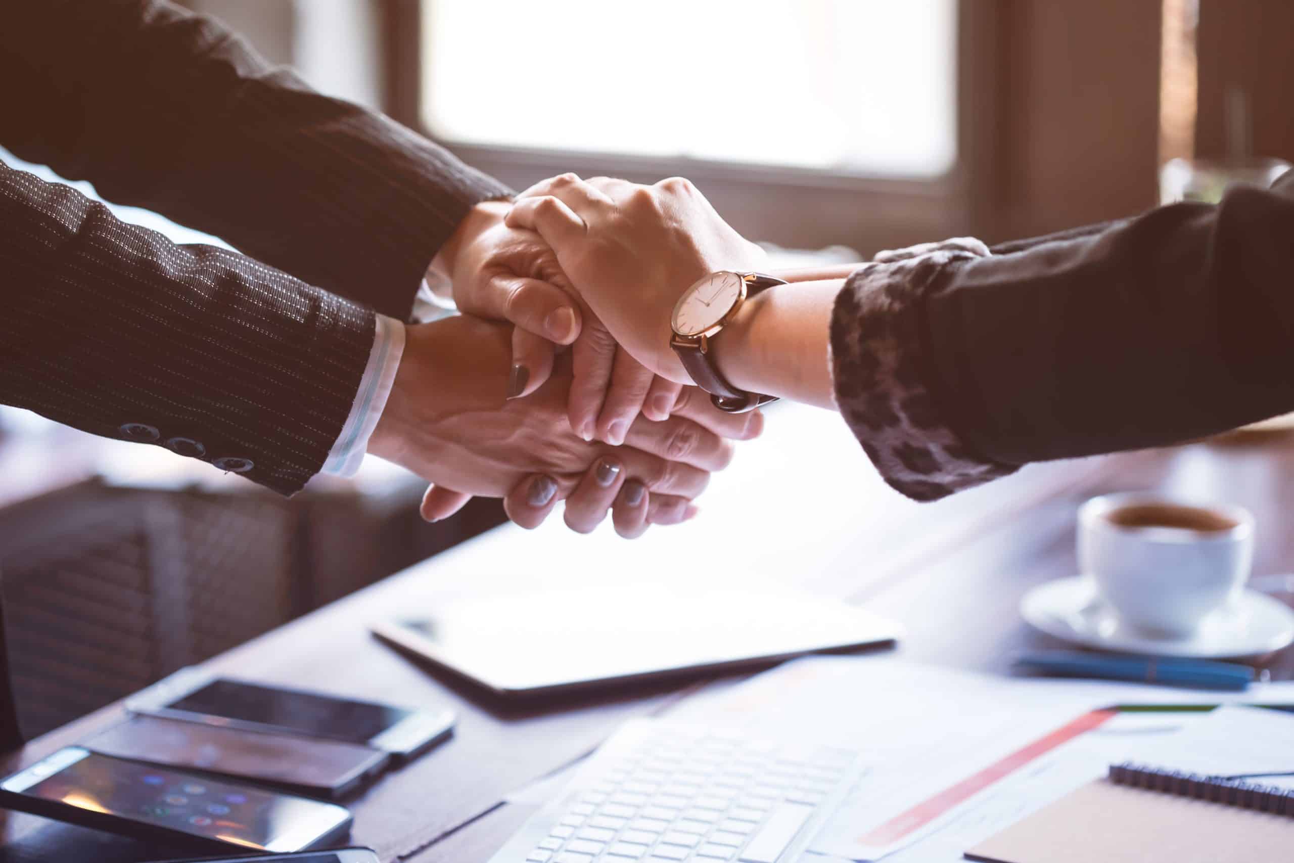 a man in a suit providing comfort with a handshake to a woman seeking divorce guidance