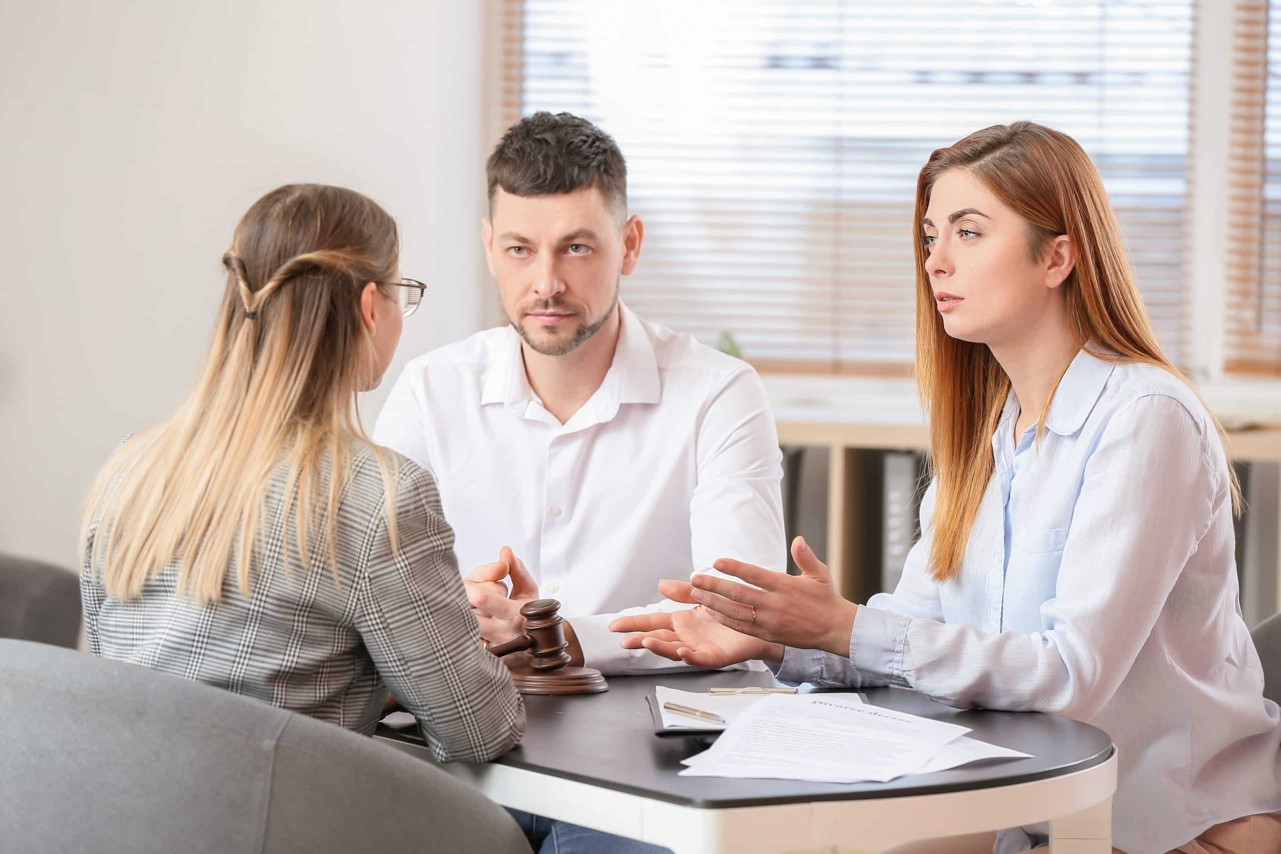 Young couple visiting a femal divorce lawyer in office