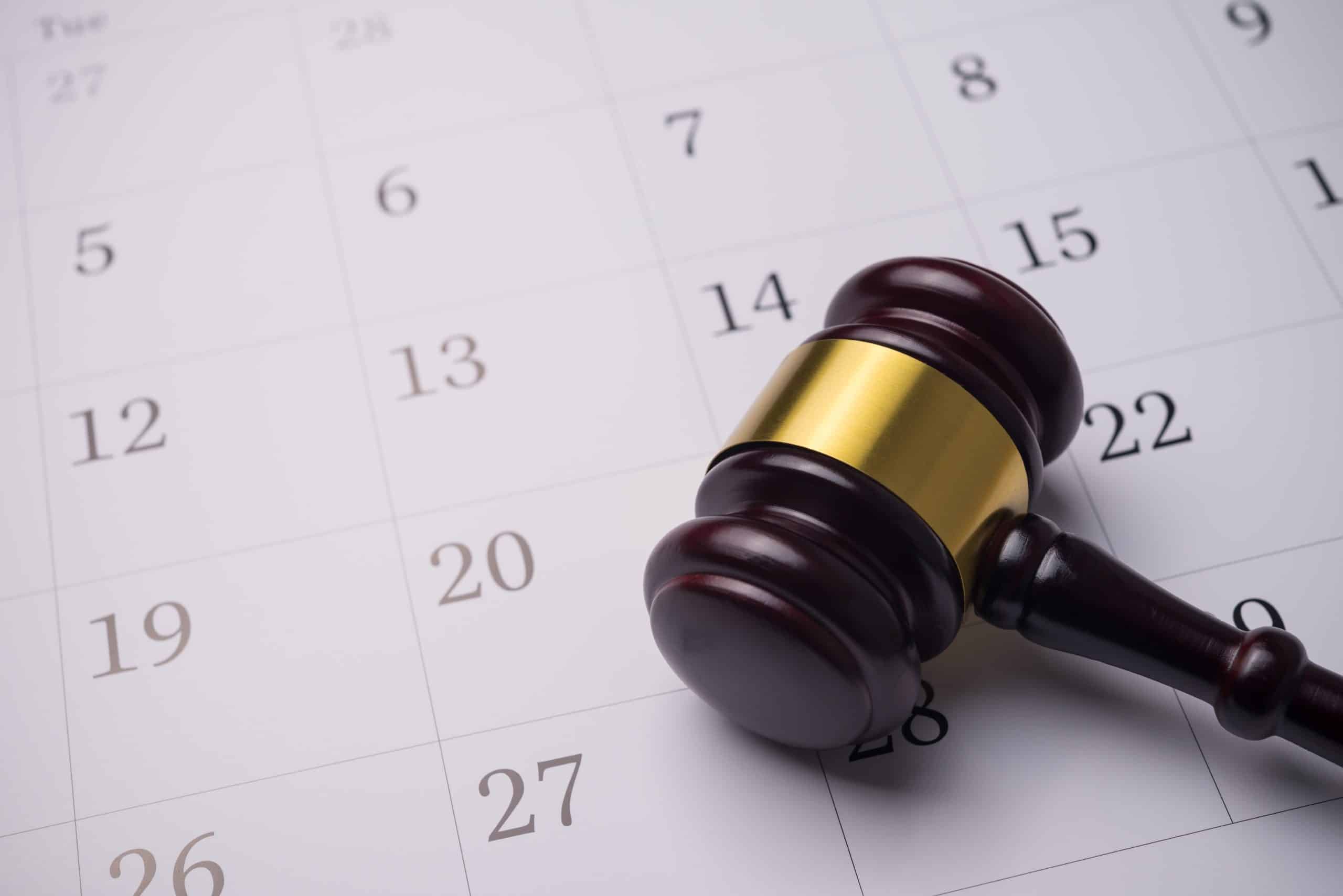 Judge wood gavel hammer on white blank calendar background copy space